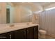 Bathroom featuring a large mirror, double sinks, and a shower at 2543 W Rabjohn Rd, Phoenix, AZ 85085