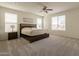 Large bedroom with natural light, plush carpeting and a ceiling fan at 2543 W Rabjohn Rd, Phoenix, AZ 85085