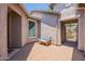 Private courtyard with a blue bench, paver flooring and stucco walls, offering a cozy outdoor space at 2543 W Rabjohn Rd, Phoenix, AZ 85085