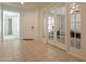 Spacious hallway with neutral tile, a view of the office, and front door at 2543 W Rabjohn Rd, Phoenix, AZ 85085