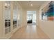 Inviting hallway with tiled floors and decorative glass French doors leading to other rooms at 2543 W Rabjohn Rd, Phoenix, AZ 85085