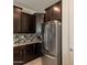 Modern kitchen with stainless steel appliances and dark wood cabinetry at 2543 W Rabjohn Rd, Phoenix, AZ 85085