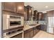Elegant kitchen with stainless steel appliances, granite countertops, and modern backsplash at 2543 W Rabjohn Rd, Phoenix, AZ 85085