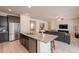 Open-concept kitchen island with seating area flowing into the living room at 2543 W Rabjohn Rd, Phoenix, AZ 85085