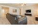 Spacious living room with plush seating, ceiling fan, and media center at 2543 W Rabjohn Rd, Phoenix, AZ 85085