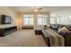 Comfortable living room with large windows, and neutral carpet flooring at 2543 W Rabjohn Rd, Phoenix, AZ 85085