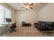 Bright and airy office with a ceiling fan and a comfortable sofa at 2543 W Rabjohn Rd, Phoenix, AZ 85085
