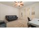 Cozy office space featuring a sofa, desk, and French doors at 2543 W Rabjohn Rd, Phoenix, AZ 85085