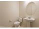 Clean powder room featuring sink and toilet at 2543 W Rabjohn Rd, Phoenix, AZ 85085