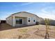 Spacious backyard features low maintenance landscaping, a covered patio, and block wall fence at 25467 W Graham Trl, Buckeye, AZ 85326