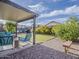 Relaxing backyard with artificial grass, shaded patio, and manicured landscaping at 2550 E Caballero St, Mesa, AZ 85213