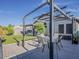 Well-maintained backyard with a covered patio, artificial turf, and a view of the surrounding neighborhood at 2550 E Caballero St, Mesa, AZ 85213