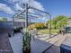 Landscaped backyard featuring a covered patio, artificial grass, and space for outdoor enjoyment at 2550 E Caballero St, Mesa, AZ 85213