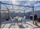 Outdoor dining set under a pergola in backyard with pavers and a grill at 2550 E Caballero St, Mesa, AZ 85213