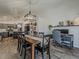 Open-concept dining area featuring wood floors and a stylish chandelier adjacent to a built-in workstation at 2550 E Caballero St, Mesa, AZ 85213