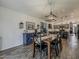 Dining room boasts wood floors and a decorative chandelier, complemented by a blue sideboard for elegant storage at 2550 E Caballero St, Mesa, AZ 85213