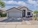 Charming single-story home with desert landscaping, a two-car garage and a covered front porch at 2550 E Caballero St, Mesa, AZ 85213