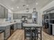 Contemporary kitchen with gray cabinetry, stainless steel appliances, an island with seating, and wood-look tile flooring at 2550 E Caballero St, Mesa, AZ 85213