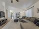 Bright living room featuring hardwood floors, a comfortable sofa, and open design to the dining area at 2550 E Caballero St, Mesa, AZ 85213