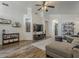 Spacious living room with hardwood floors, comfortable seating, and open to the dining area for entertaining at 2550 E Caballero St, Mesa, AZ 85213