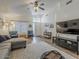 Inviting living room with hardwood floors, plush seating, a ceiling fan, and a view of the entryway at 2550 E Caballero St, Mesa, AZ 85213
