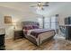 Inviting main bedroom with wood floors, natural light, and ceiling fan at 2550 E Caballero St, Mesa, AZ 85213