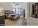 Comfortable main bedroom with wood floors, large windows and modern ceiling fan at 2550 E Caballero St, Mesa, AZ 85213