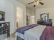 Cozy main bedroom featuring wood floors and views of an en-suite bathroom and walk-in closet at 2550 E Caballero St, Mesa, AZ 85213