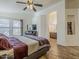 Spacious main bedroom with wood floors leading to a view of an en-suite bathroom at 2550 E Caballero St, Mesa, AZ 85213