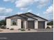 Charming single-story home featuring a two-car garage, neutral stucco, a low-maintenance yard, and a dark trim package at 26406 N 77Th Dr, Peoria, AZ 85383