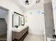 Bright bathroom featuring dual sinks, modern lighting, and glass shower at 3221 N 37Th St # 26, Phoenix, AZ 85018