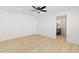 Bright bedroom with decorative wall paneling, ceiling fan, and bathroom access at 3221 N 37Th St # 26, Phoenix, AZ 85018