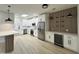 Bright kitchen features stainless steel appliances, island with seating and wood panel accent wall with shelving at 3221 N 37Th St # 26, Phoenix, AZ 85018