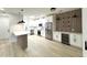 Bright kitchen features stainless steel appliances, island with seating and wood panel accent wall with shelving at 3221 N 37Th St # 26, Phoenix, AZ 85018