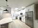 Bright kitchen features stainless steel appliances, island with seating and white cabinetry at 3221 N 37Th St # 26, Phoenix, AZ 85018