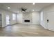 Bright living room features a ceiling fan, white walls, and modern fireplace at 3221 N 37Th St # 26, Phoenix, AZ 85018