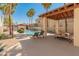 Community pool area featuring lounge chairs and covered seating, ideal for sunny days at 3221 N 37Th St # 26, Phoenix, AZ 85018