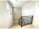 Light-filled staircase features wooden treads and black metal railing at 3221 N 37Th St # 26, Phoenix, AZ 85018