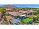 Aerial view of a backyard featuring a putting green, outdoor kitchen, and covered patio at 3498 E Ravenswood Dr, Gilbert, AZ 85298