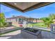 Beautiful outdoor space featuring a covered patio, fire pit, and putting green at 3498 E Ravenswood Dr, Gilbert, AZ 85298