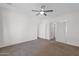 Spacious bedroom featuring a ceiling fan, soft carpet, and a sliding-door closet at 3498 E Ravenswood Dr, Gilbert, AZ 85298
