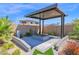 Cozy covered fire pit area, perfect for outdoor entertaining with great landscaping at 3498 E Ravenswood Dr, Gilbert, AZ 85298