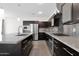 Modern kitchen features stainless steel appliances and a center island with sink at 3498 E Ravenswood Dr, Gilbert, AZ 85298