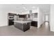 Bright kitchen featuring stainless steel appliances, dark cabinets, and center island at 3498 E Ravenswood Dr, Gilbert, AZ 85298