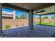 Large covered patio with stone flooring, ceiling fan, and outdoor access at 3498 E Ravenswood Dr, Gilbert, AZ 85298