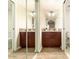 Bathroom with dual sink vanity, granite countertop, and framed mirrors at 3554 W Aire Libre Ave, Phoenix, AZ 85053