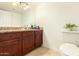 Bathroom vanity with granite countertops, ample cabinet space, and a decorative mirror at 3554 W Aire Libre Ave, Phoenix, AZ 85053