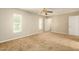 Bright bedroom with carpet flooring, a ceiling fan, and ample natural light at 3554 W Aire Libre Ave, Phoenix, AZ 85053