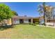 Well-maintained front yard with healthy grass and nice landscaping at 3554 W Aire Libre Ave, Phoenix, AZ 85053