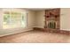Comfortable living room with a brick fireplace and large windows at 3554 W Aire Libre Ave, Phoenix, AZ 85053